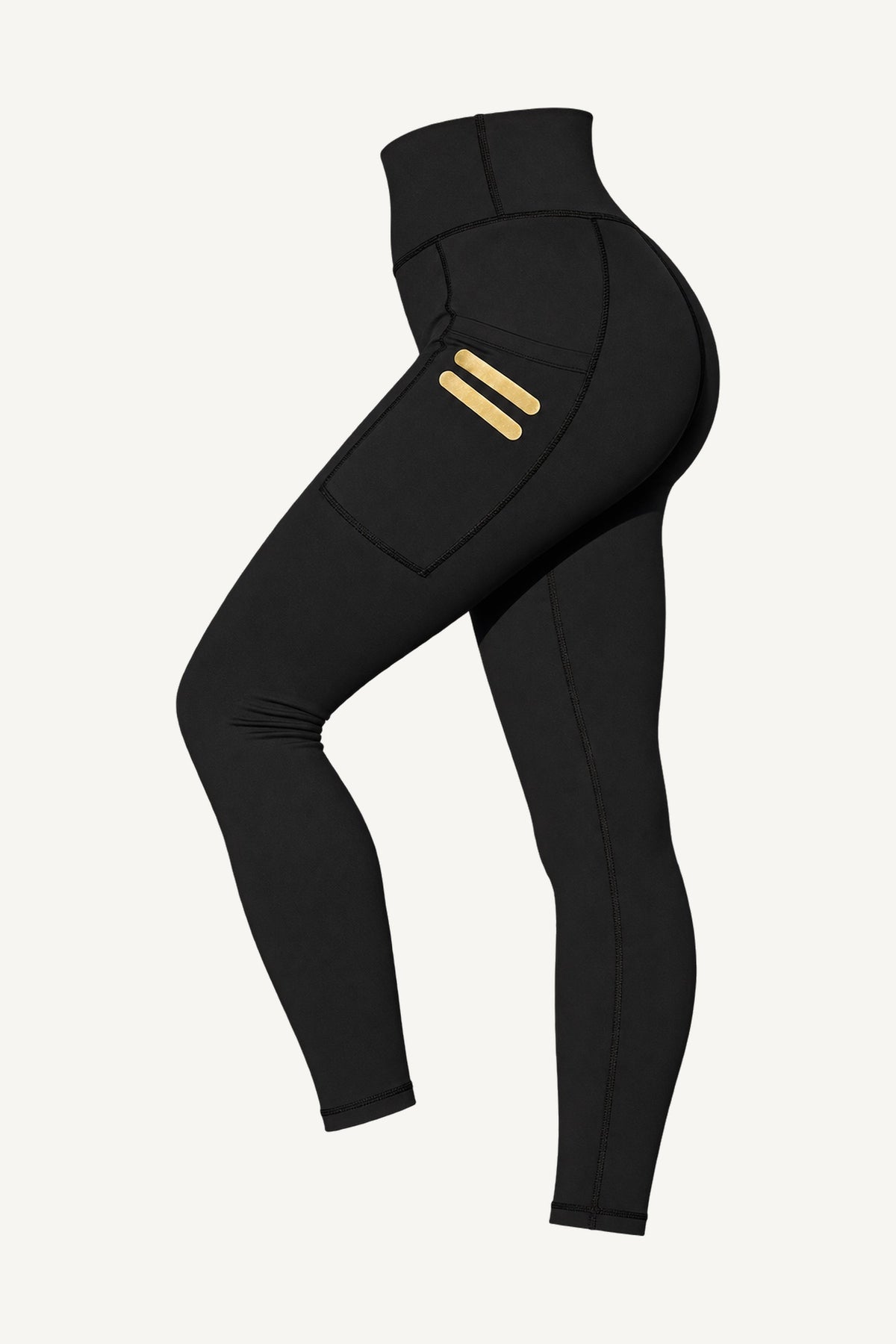 Iconic Stripe Tights Med Fickor fritlagt, skråt forfra. Lommer på begge ben med to korte guldstreger.